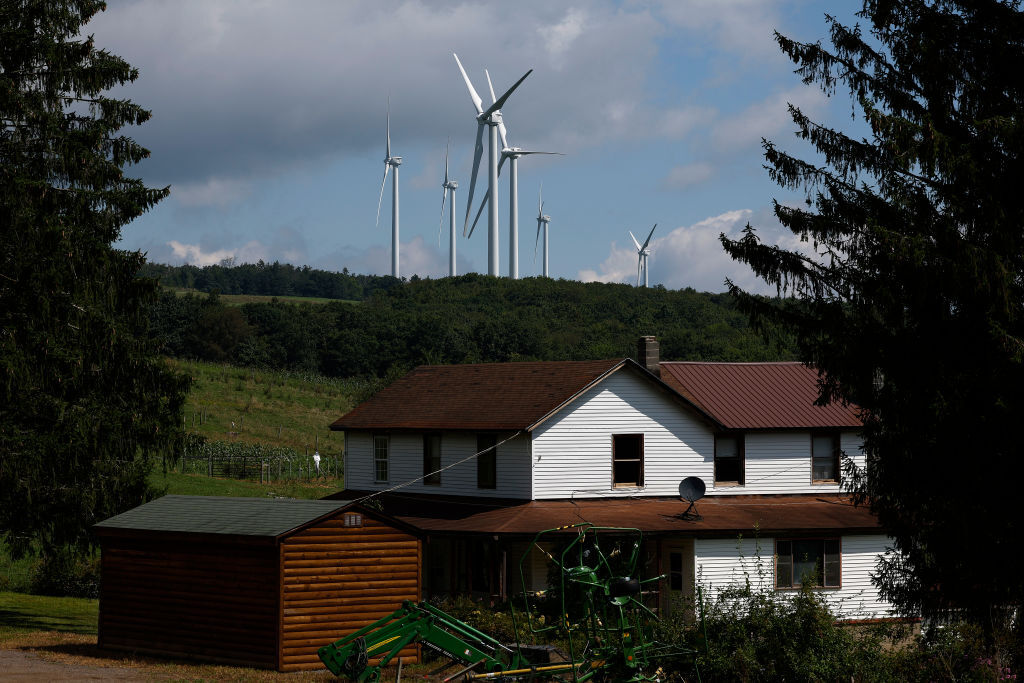 Image of wind turbines behind a house